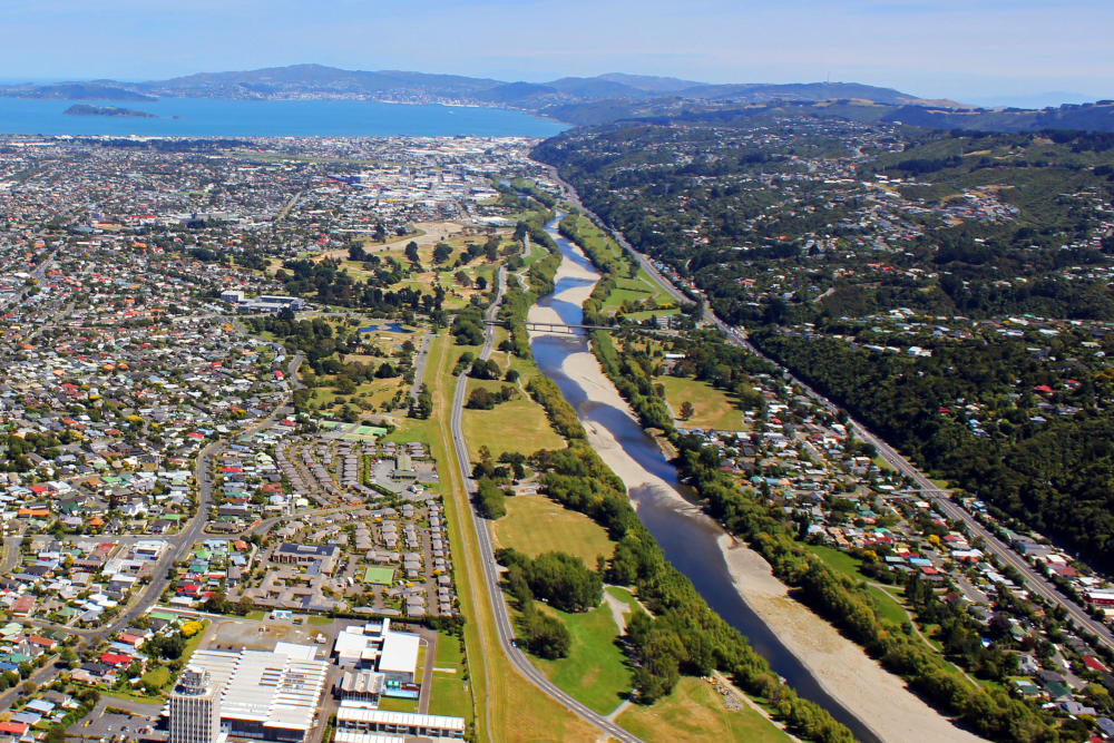 Aerial view of Lower Hutt from Avalon to the harbour and Wellington city. Foreground is filled with the Lower Hutt suburbs, with the Western hills and the Hutt River filling the right side of the view.